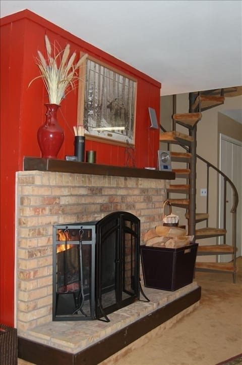 Wood burning fireplace and quaint spiral staircase to loft.