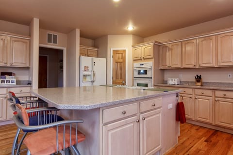 Kitchen. Large island with gas stove top. Well stocked.