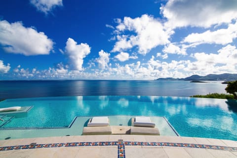 An infinity pool, sun loungers