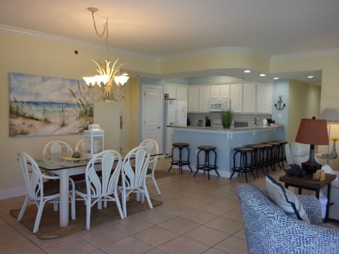 The dining table for 6 with a view of kitchen.