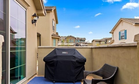 Outdoor patio featuring a grill and a bench