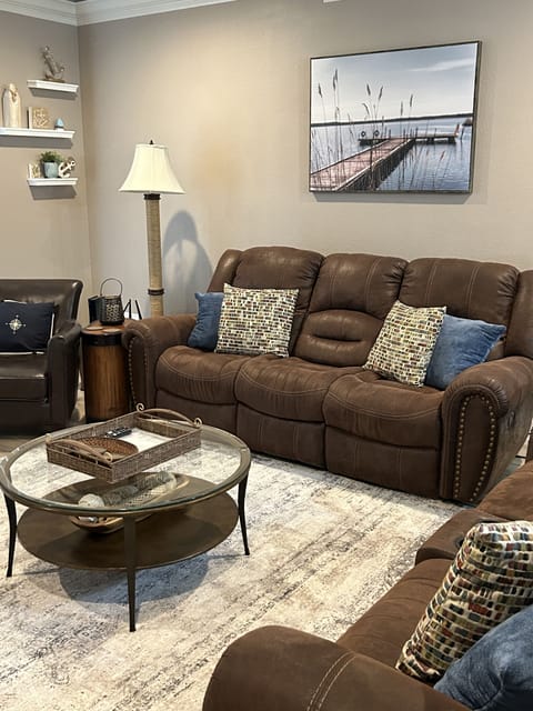Flex Steel reclining sofa, loveseat and a small leather chair in family room. 

