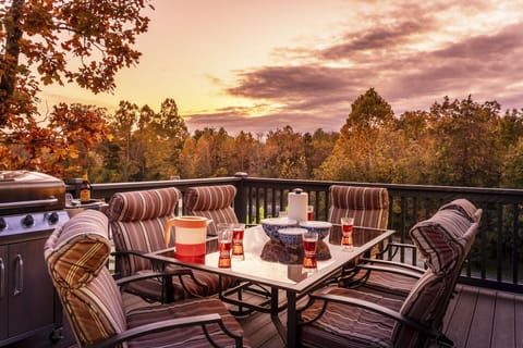 Large deck with propane grill and patio set. Basketball court and field in view