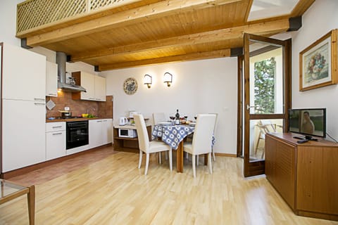 The living room with dinner table and view of the kitchen