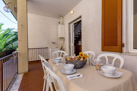 Rear terrace with dining area and entrance to the apartment