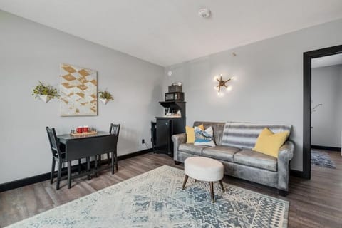 Living Room - With drop leaf table for two or four, extra folding chairs beside mini-frig, kitchenette with Keurig coffee maker, K-cups, and microwave.