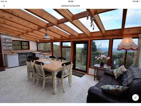 One of the dining areas and kitchens in the conservatory with fabulous views.