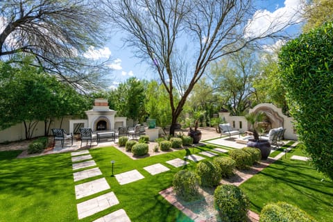 A backyard with a lush and enchanting view, offering a serene and relaxing retreat amidst verdant greenery.