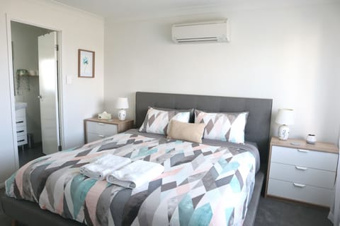 Master bedroom with king bed, ensuite, air con and ceiling fan