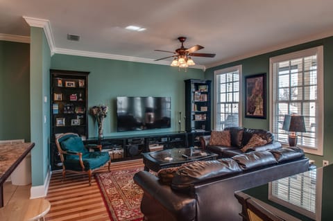 Living room with 70" TV, hardwood floors, plenty of seating!