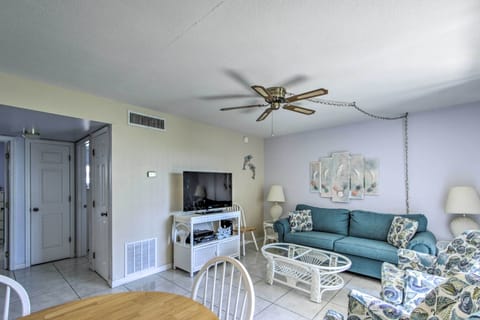 The kitchen and the living room both have ceiling fans.