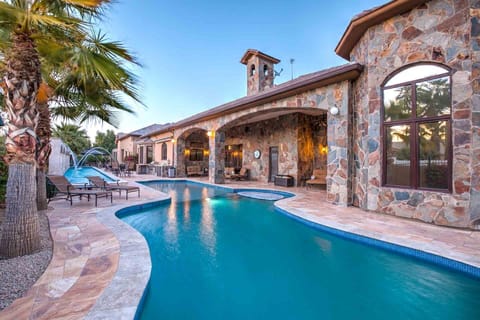 Luxury stone villa with private pool, hot tub, and arched patios.