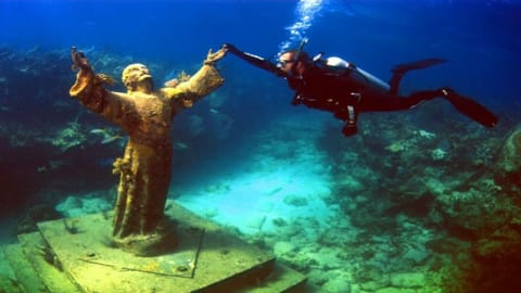 Take a dive down to the famous Christ of the Abyss. 