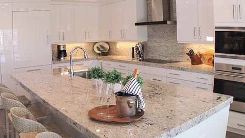 Gather for drinks or snacks as meals are prepared in the well-equipped kitchen