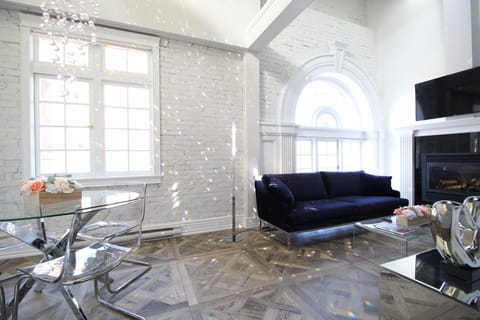 Entrance level - Sitting room - Original arched wood window and brick walls