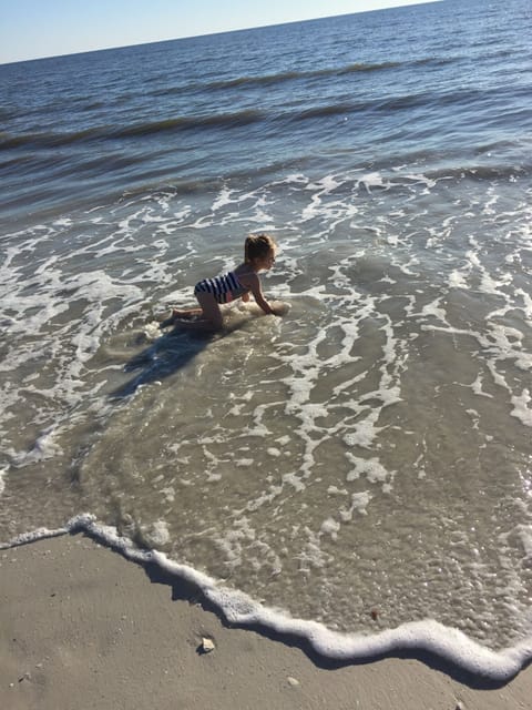Granddaughter playing in the calm gulf water