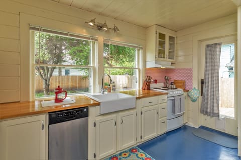 The kitchen leads to the deck and a large, simple yard.