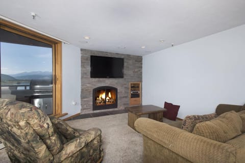 Living room with smart TV and gas fireplace.