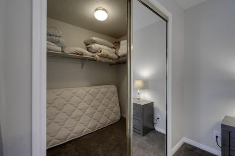Master bedroom walk-in closet. Twin mattress for extra sleeping.