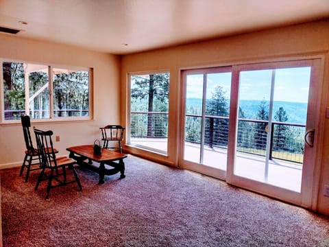 Living room with views, on main floor, next to kitchen and wraparound deck.
