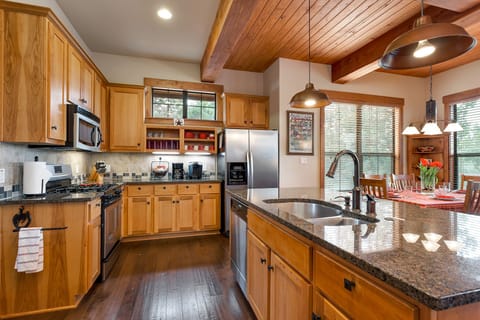 Full stocked kitchen with microwave, gas oven, large granite island with sink.