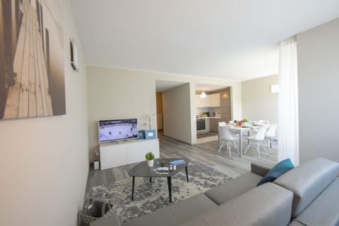 Living room with a sitting area, television and dining area
