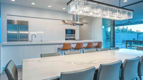 Bright modern kitchen with seamless indoor-outdoor dining.