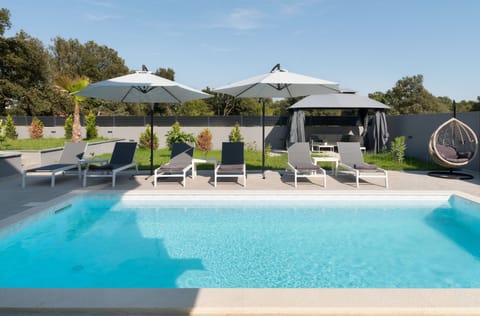 A heated pool, sun loungers