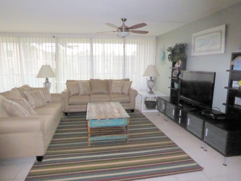 Great room is comfortable, spacious with ample seating, flat screen TV, DVR.