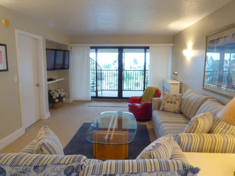 Great room with large flat screen TV slider to Lanai & spiral staircase to roof.