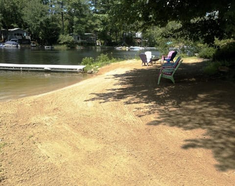 Large level beach area has natural sand, a fire pit and is power-raked each week