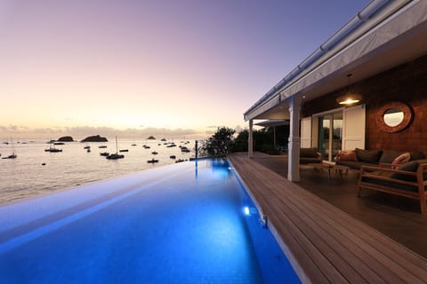 An infinity pool, sun loungers