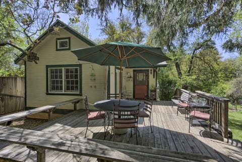 Umbrella-shaded seating for six, with additional bench seating
