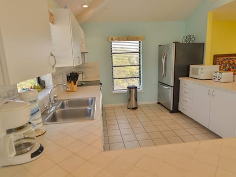 Large kitchen with stainless steel appliances including a french door fridge