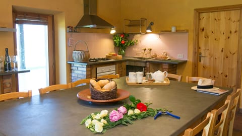 Large kitchen with dining table and access to outdoor eating area