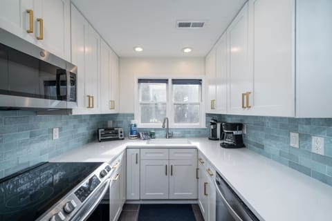 Lovely blue subway tile and custom white cabinetry.