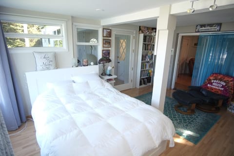 Bedroom with queen bed and view of marina