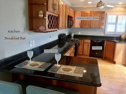 Large complete kitchen is stunning with black granite