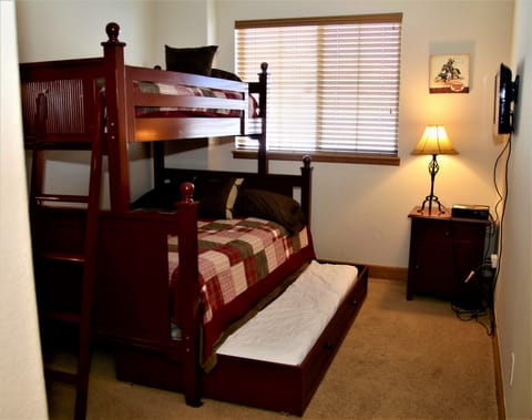 Bunk Room in lower level Twin over Full with twin trundle. TV for movies only.