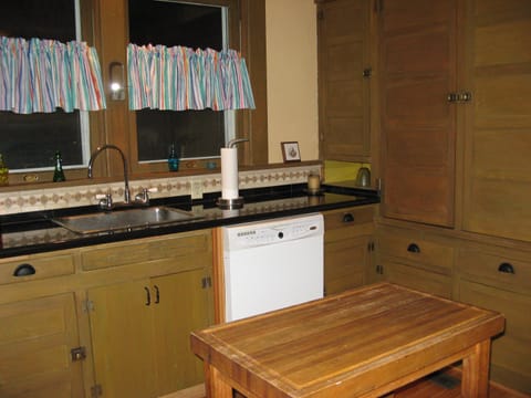 Fully equipped kitchen. Vintage cabinets complimented by granite and tile.