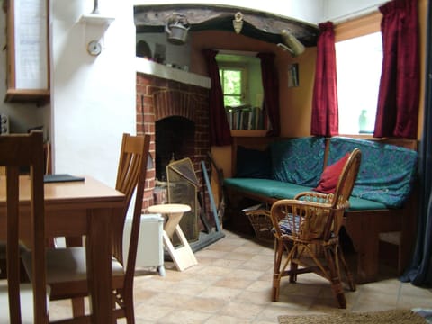 One side of sitting room with wood and coal burning open fireplace.