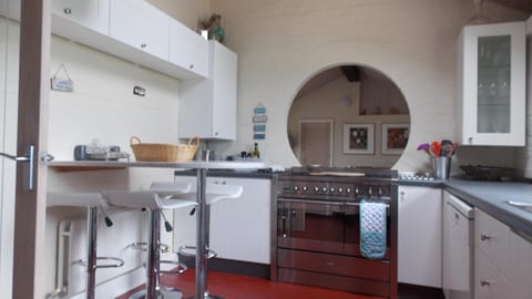 Kitchen with breakfast bar and range cooker