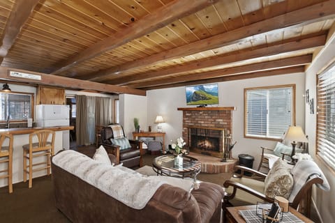The comfortable room is accented by rich open-beam ceilings.