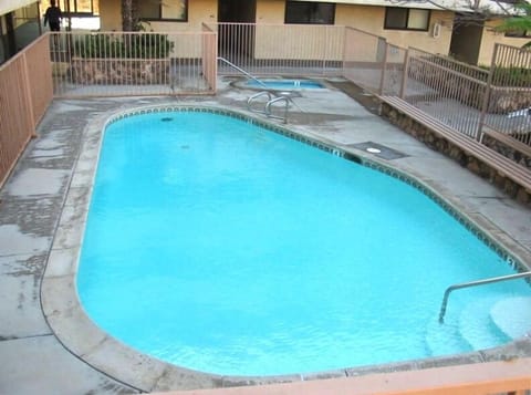 Heated Pool with Hot Tub in the background. Pool hours are 9am-9pm.