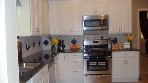 Spotless white cabinets, and granite countertops!