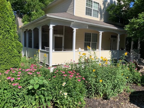 Our Lakeside cottage in full bloom, view of our front porch and screened porch