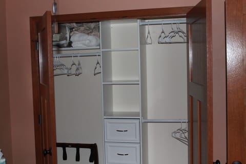 Master bedroom closet with iron and ironing board