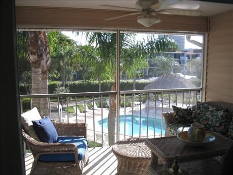 View of Pool Area from Screened Lanai which has Comfortable and Spacious Seating