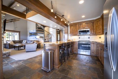 Fully stocked kitchen with living room view. Heated slate floors.