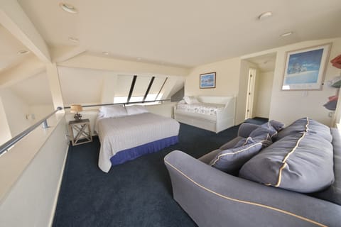 Loft area with queen bed and twin trundle bed.
